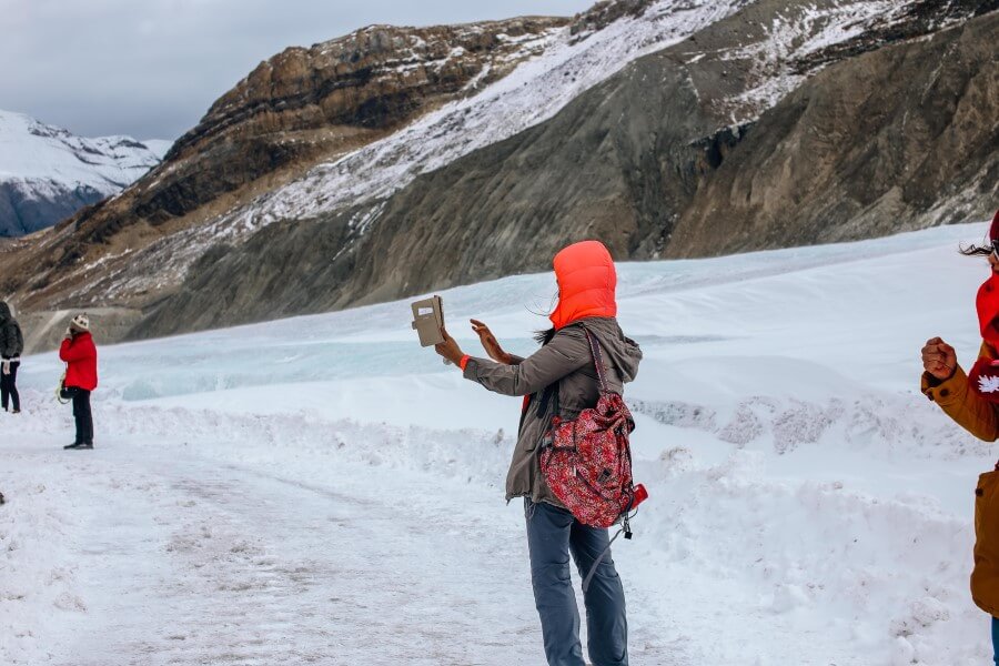 people hiking in snow on a budget